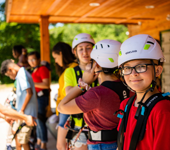 A group of kids in safety gear at Lake Erie Canopy Tours
